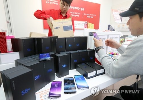资料图片：4月13日，在一移动运营商代理店，工作人员正在为销售Galaxy S8系列手机作准备。（韩联社）