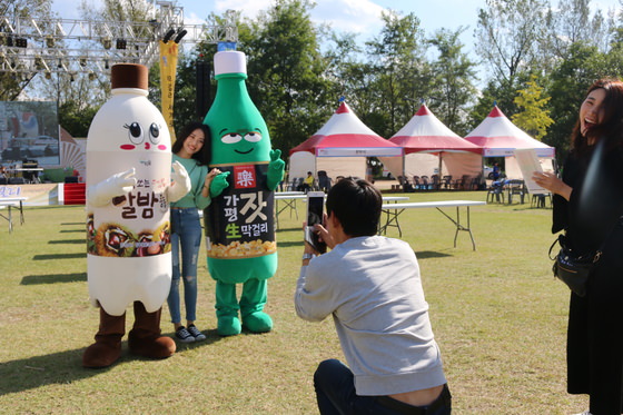 图为参加去年10月举行的“甲鱼岛马格利米酒庆典”的游客与人偶合照。（照片来源：京畿道）