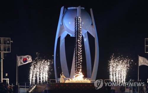 资料图片：2月9日，在平昌奥林匹克体育场举行的2018平昌冬奥会开幕式上，韩国花滑名将金妍儿接过火炬并点燃奥运圣火。（韩联社）