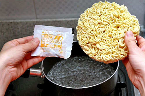 2. 倒入3杯水(600 cc)至锅内并煮滚,再放入面和调味包煮5分钟。