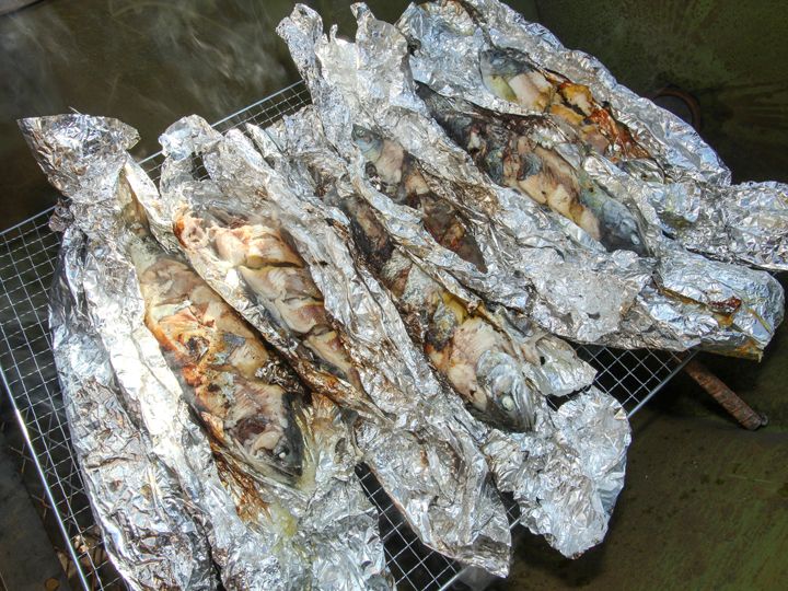 打开锡纸后冒着香味的新鲜烤鱼